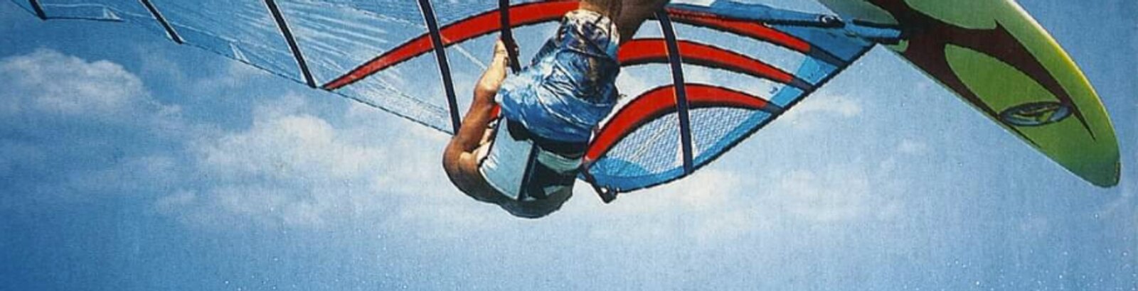 A windsurfer jumping, seen from below