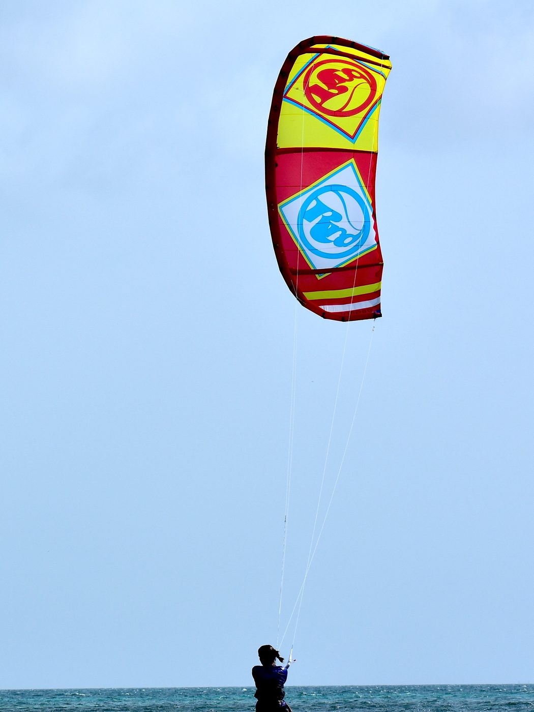 Kitesurfer launching a kite on the beach
