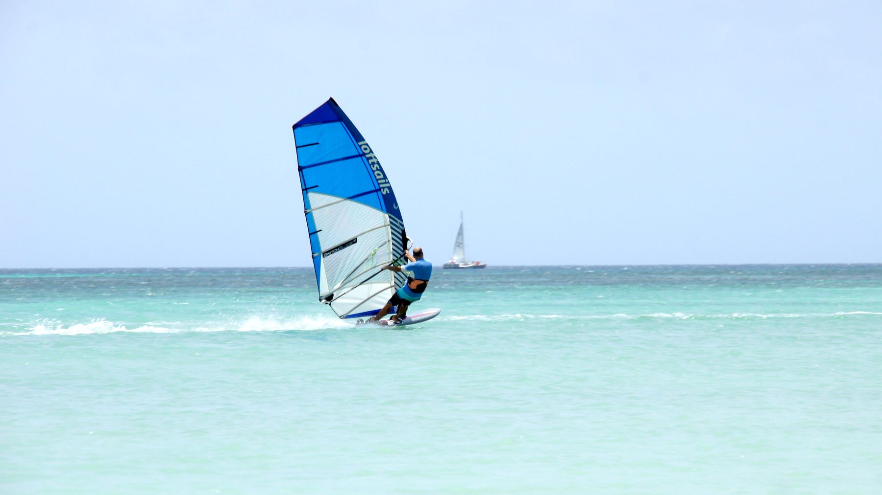 Windsurfer planing on flat water