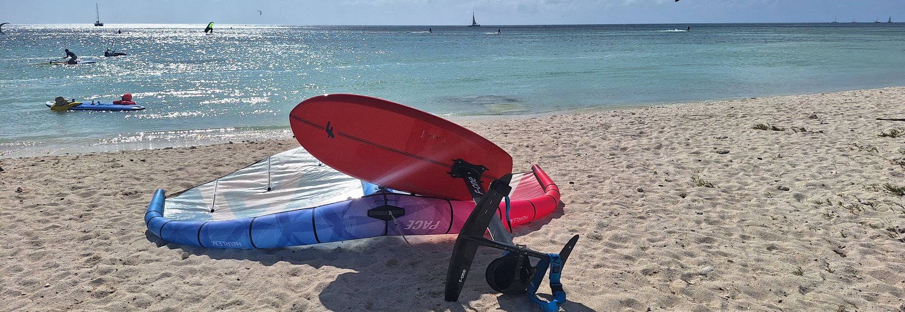 Wing and foil board on the sand