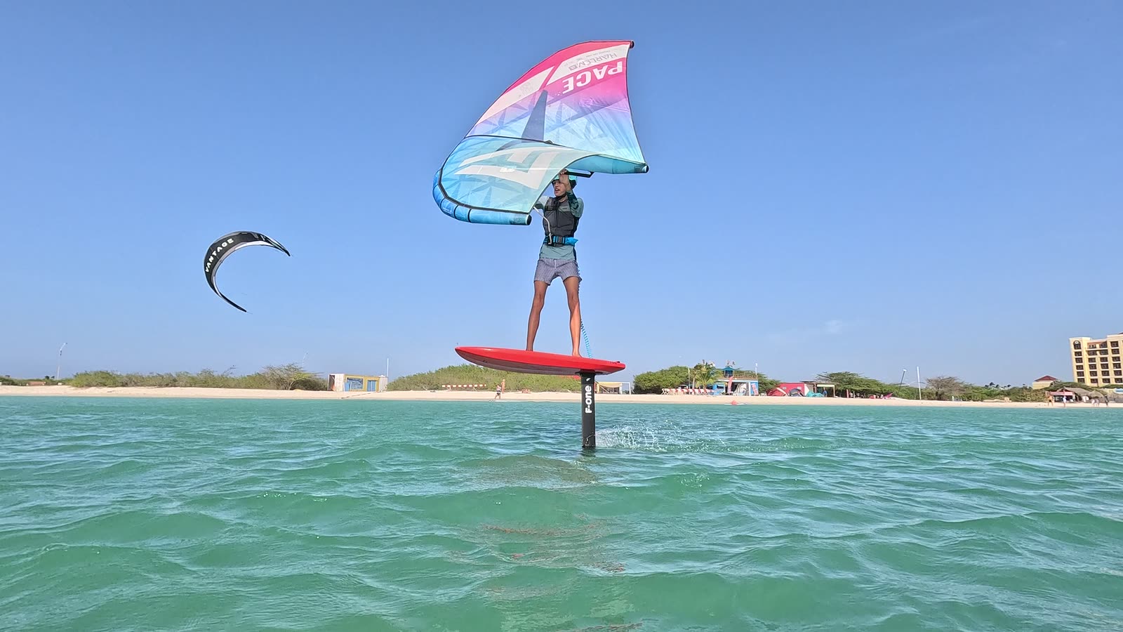 Wingfoiler riding above the water